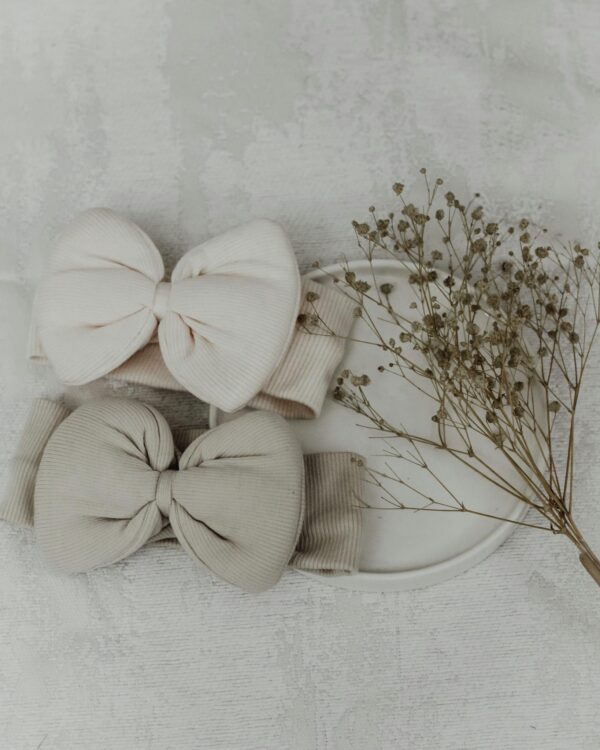 Charming baby headbands in pastel colors with bows, perfect for newborn fashion and lifestyle photography.
